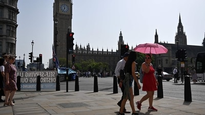 Pedestrians walk in the midday sun past the Palace of Westminster in central London. (AFP) Pedestrians walk in the midday sun past the Palace of Westminster in central London. (AFP)