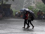 Pedestrians seen walking during heavy rains in Navi Mumbai.