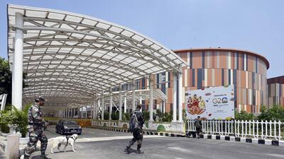 A security personnel seen along with the sniffer dog outside Bharat Mandapam ahead of G20 Summit at Pragati Maidan, in New Delhi. (Hindustan Times) A security personnel seen along with the sniffer dog outside Bharat Mandapam ahead of G20 Summit at Pragati Maidan, in New Delhi. (Hindustan Times)
