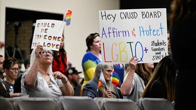 Parents, students, and staff of Chino Valley Unified School District hold up signs to protect LGBTQ+ policies at Don Antonio Lugo High School, on June 15, in Chino, Calif. (AP) Parents, students, and staff of Chino Valley Unified School District hold up signs to protect LGBTQ+ policies at Don Antonio Lugo High School, on June 15, in Chino, Calif. (AP)