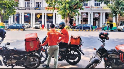 Delivery executives wait for orders in CP on Thursday. (HT PHOTO) Delivery executives wait for orders in CP on Thursday. (HT PHOTO)
