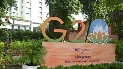 A security personnel walks past the G20 logo installed along a street in New Delhi on September 7, 2023. (AFP ) A security personnel walks past the G20 logo installed along a street in New Delhi on September 7, 2023. (AFP )
