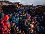 People gather after watching the sunrise from the summit of Mount Fuji, some 70 kilometres (43 miles) west of the capital Tokyo. Japanese authorities are gearing up to impose crowd control measures for the first time on Mount Fuji this weekend for an expected holiday rush by thousands of sometimes ill-prepared trekkers. 