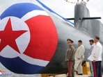 North Korean leader Kim Jong Un attends what state media report was a launching ceremony for a new tactical nuclear attack submarine in North Korea,