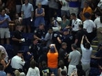 Police officers remove a climate change protester as play was halted.