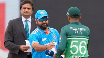 India's captain Rohit Sharma, in blue, shakes hands with his Pakistani counterpart Babar Azam (AP) India's captain Rohit Sharma, in blue, shakes hands with his Pakistani counterpart Babar Azam (AP)