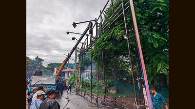 An anti-encroachment squad of Pune Cantonment Board (PCB) razed three large hoardings at Bhairoba Nullah and Pulgate on Friday. (HT PHOTO)