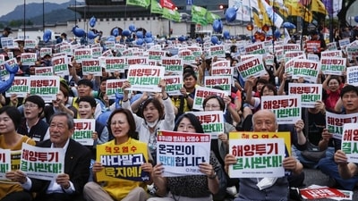 Demonstrators hold signs reading "No Dumping" and "No to the Sea, Yes in the Land" during a protest against Japan's plan to release treated wastewater from the Fukushima nuclear disaster site into the Pacific Ocean, in Seoul, South Korea (Bloomberg) Demonstrators hold signs reading "No Dumping" and "No to the Sea, Yes in the Land" during a protest against Japan's plan to release treated wastewater from the Fukushima nuclear disaster site into the Pacific Ocean, in Seoul, South Korea (Bloomberg)