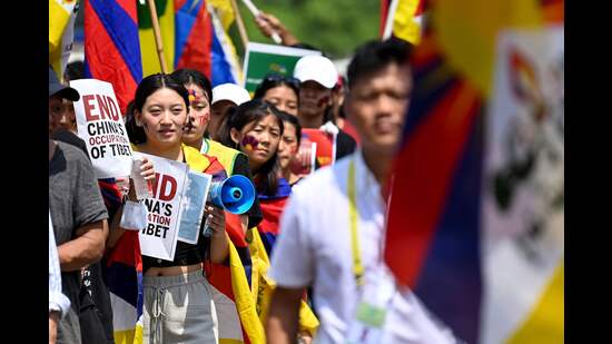 Members of the Tibetan Youth Congress (TYC) hold placards as they carry the Tibetan flags during a protest against China's alleged occupation over Tibet and their partcipation in the upcoming G20 India summit in New Delhi on September 8. (AFP)