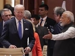 Prime Minister Narendra Modi points to US President Joe Biden his seat as they arrive for the first session of the G20 Summit in New Delhi.