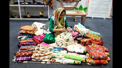 A woman inside a stall at the G20 Crafts Bazaar, an exhibition-cum-sale, at the G20 Summit at International Media Center of Pragati Maidan in New Delhi on Saturday. Patiala-based phulkari artist and Padma Shri awardee Lajwanti showcased embroidery products at Craft Bazaar in Bharat Mandapam International Exhibition and Convention Centre unveiled at the G20 Summit on Saturday. (ANI)