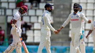 India's Ravindra Jadeja, right, celebrates with teammate Virat Kohli the dismissal LBW of West Indies' Tagenarine Chanderpaul on day three of their first cricket Test match at Windsor Park in Roseau, Dominica (AP)