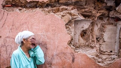 A woman reacts standing infront of her earthquake-damaged house in the old city in Marrakesh on September 9. (AFP)