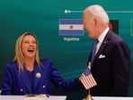 Italian Prime Minister Giorgia Meloni and U.S. President Joe Biden react at the launch of the Global Biofuels Alliance at the G20 summit in New Delhi, India.
