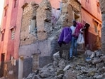 Morocco Earthquake: A man carries belongings out of his damaged house, in the aftermath of a deadly earthquake in Moulay Brahim, Morocco.