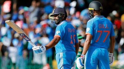 Rohit Sharma raises his bat as he completes his half-century (ANI ) Rohit Sharma raises his bat as he completes his half-century (ANI )