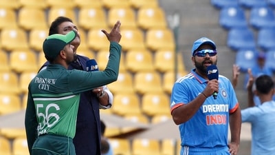 Pakistan Babar Azam tosses the coin, watched by Indian captain Rohit Sharma before the start Asia Cup 2023 match at Pallekele (AP)