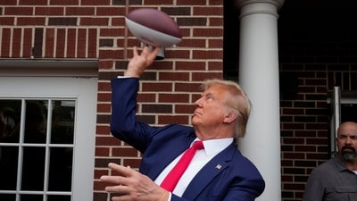 Former President Donald Trump throws a football to the crowd during a visit to the Alpha Gamma Rho, agricultural fraternity, at Iowa State University before an NCAA college football game between Iowa State and Iowa, Saturday, Sept. 9, 2023, in Ames, Iowa. (AP Photo/Charlie Neibergall) (AP) Former President Donald Trump throws a football to the crowd during a visit to the Alpha Gamma Rho, agricultural fraternity, at Iowa State University before an NCAA college football game between Iowa State and Iowa, Saturday, Sept. 9, 2023, in Ames, Iowa. (AP Photo/Charlie Neibergall) (AP)