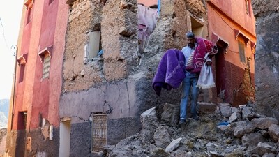 Morocco Earthquake: A man carries belongings out of his damaged house, in the aftermath of a deadly earthquake in Moulay Brahim, Morocco. (Reuters)