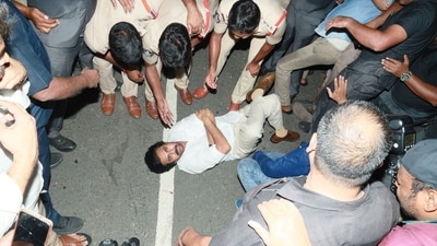 Pawan Kalyan lies on the road in protest against the police blocking his convoy from entering Andhra Pradesh. Pawan Kalyan lies on the road in protest against the police blocking his convoy from entering Andhra Pradesh.