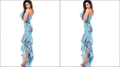 Kiara's stunning blue dress features an off-shoulder design with balloon sleeves on one side, an asymmetric neckline, a figure-hugging fit, multiple layers of ruffles at the bottom and a captivating black and white floral print all over. (Instagram/@tanghavri) Kiara's stunning blue dress features an off-shoulder design with balloon sleeves on one side, an asymmetric neckline, a figure-hugging fit, multiple layers of ruffles at the bottom and a captivating black and white floral print all over. (Instagram/@tanghavri)