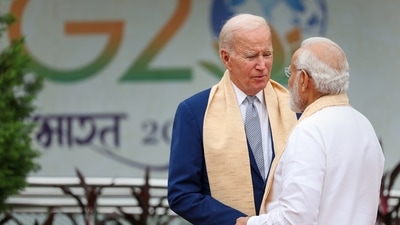 PM Narendra Modi and US President Joe Biden speak to each other at Rajghat as they arrive to pay respects. (AP) PM Narendra Modi and US President Joe Biden speak to each other at Rajghat as they arrive to pay respects. (AP)
