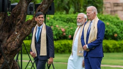 PM Modi, UK PM Rishi Sunak and US President Joe Biden seen taking a walk together at Rajghat. (PTI) PM Modi, UK PM Rishi Sunak and US President Joe Biden seen taking a walk together at Rajghat. (PTI)