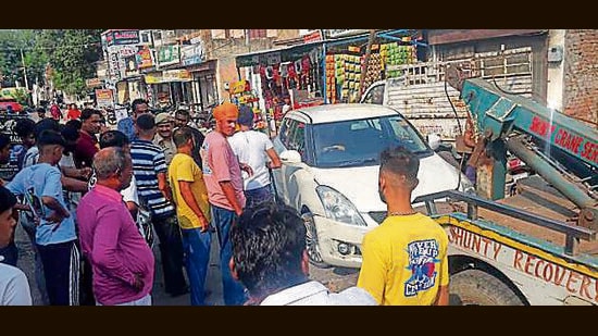Police removing damaged car of ASI Kuldeep Singh from the spot after the imposters hit the vehicle in a bid to escape. (HT PHOTO)