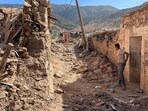 A person stands near damaged houses in Tafeghaghte, a remote village of the High Atlas mountains, following a powerful earthquake in Morocco, September 10, 2023. (Reuters)