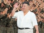 North Korean leader Kim Jong Un waves next to participants of the civil defense military parade commemorating the 75th anniversary of the founding of the country, in this picture released on September 11, 2023. (Reuters)