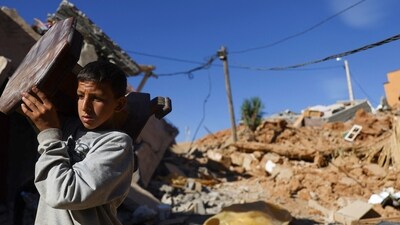 Morocco Earthquake: A person carries an item of furniture, in the aftermath of a deadly earthquake, in a hamlet on the outskirts of Talaat N'Yaaqoub, Morocco. (Reuters)