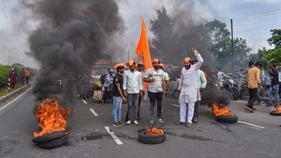 Maratha Kranti Morcha members burn tires on Pune-Solapur Highway while staging 'Rasta Roko' protest (PTI) Maratha Kranti Morcha members burn tires on Pune-Solapur Highway while staging 'Rasta Roko' protest (PTI)
