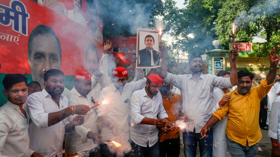 Samajwadi Party workers celebrating the victory of party candidate Sudhakar Singh in the Ghosi constituency by-election, in Lucknow. (FILE PHOTO)