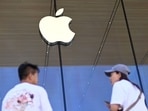 People stand outside an Apple store