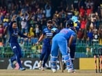 Sri Lanka's Dunith Wellalage (L) celebrates with teammates after taking the wicket of India's captain Rohit Sharma