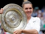 Romania's Simona Halep poses with the trophy as she celebrates after winning the final against Serena Williams