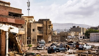 Destroyed vehicles and damaged buildings are seen in the eastern city of Derna, in the aftermath of Storm Daniel, about 290 kilometres east of Benghazi. (The Press Office of Libyan Prime Minister / AFP) Destroyed vehicles and damaged buildings are seen in the eastern city of Derna, in the aftermath of Storm Daniel, about 290 kilometres east of Benghazi. (The Press Office of Libyan Prime Minister / AFP)