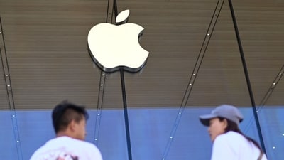 People stand outside an Apple store (AFP) People stand outside an Apple store (AFP)