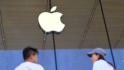 People stand outside an Apple store (AFP) People stand outside an Apple store (AFP)