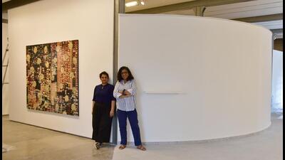 Curator Shaleen Wadhwana (left) and gallerist Shireen Gandhy stand flanked by a , 6x8 feet diptych by Dhruvi Acharya titled “Who was and is” and 9x44 feet wall conceptualised by Jitish Kallat to re-create the earlier, smaller Chemould gallery in this space. The gallery, now called Chemould Prescott Road, will complete 60 years on September 16, and has a three-month long programme of exhibitions, walk-throughs, and talks planned. (Bhushan Koyande/HT Photo) Curator Shaleen Wadhwana (left) and gallerist Shireen Gandhy stand flanked by a , 6x8 feet diptych by Dhruvi Acharya titled “Who was and is” and 9x44 feet wall conceptualised by Jitish Kallat to re-create the earlier, smaller Chemould gallery in this space. The gallery, now called Chemould Prescott Road, will complete 60 years on September 16, and has a three-month long programme of exhibitions, walk-throughs, and talks planned. (Bhushan Koyande/HT Photo)
