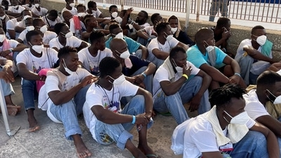 Newly arrived migrants wait to embark on a ferry to the mainland, in the Sicilian island of Lampedusa, Italy. (Reuters)