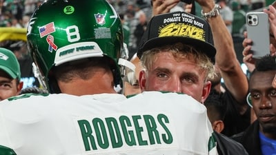 Sep 11, 2023; East Rutherford, New Jersey, USA; New York Jets quarterback Aaron Rodgers (8) is greeted by social media personality Jake Paul before the game against the Buffalo Bills at MetLife Stadium. Mandatory Credit: Vincent Carchietta-USA TODAY Sports (USA TODAY Sports via Reuters Con)