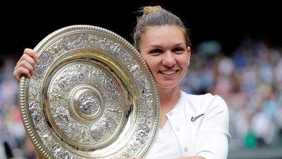 Romania's Simona Halep poses with the trophy as she celebrates after winning the final against Serena Williams (REUTERS)