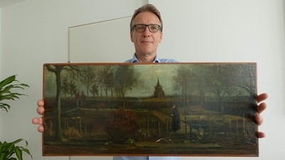 Dutch art detective Arthur Brand shows a portrait of him posing with the painting title "Parsonage Garden at Nuenen in Spring", painted by Vincent van Gogh in 1884. (AFP) Dutch art detective Arthur Brand shows a portrait of him posing with the painting title "Parsonage Garden at Nuenen in Spring", painted by Vincent van Gogh in 1884. (AFP)
