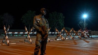 A national police officer stands guard as supporters of Niger's National Council for Safeguard of the Homeland protest outside the French and Niger airbase in Niamey on September 9, 2023 to demand the departure of the French army from Niger. (AFP) A national police officer stands guard as supporters of Niger's National Council for Safeguard of the Homeland protest outside the French and Niger airbase in Niamey on September 9, 2023 to demand the departure of the French army from Niger. (AFP)