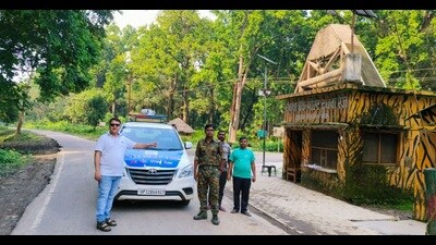 Transport and Dudhwa forest officials with an interceptor car in Dudhwa on Tuesday. (HT Photo)