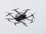 An automated drone taxi hovers in the air during an unveiling of the driverless technology outside Hadassah Medical Center in Jerusalem