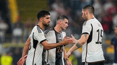 Germany's Emre Can, left, greets teammate Niklas Sule at the end of the international friendly soccer match against France in Dortmund (AP)