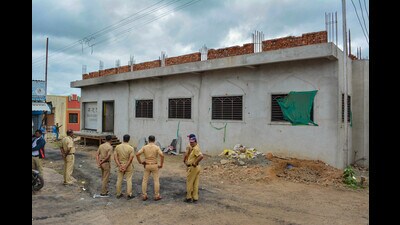 Police personnel stand guard after a clash between two groups over a controversial post on social media. (PTI)