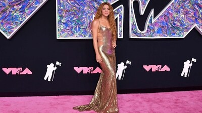 Colombian singer Shakira arrives for the MTV Video Music Awards at the Prudential Center. Shakira made heads turn on the pink carpet in a golden slip gown featuring backless detailing and a floor-sweeping train on the back. Her goddess-like locks accentuated the look. (AFP) Colombian singer Shakira arrives for the MTV Video Music Awards at the Prudential Center. Shakira made heads turn on the pink carpet in a golden slip gown featuring backless detailing and a floor-sweeping train on the back. Her goddess-like locks accentuated the look. (AFP)